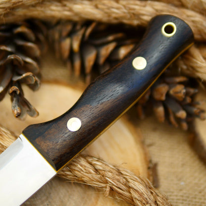 An Adventure Sworn Tradesman bushcraft knife with ziricote handle scales.