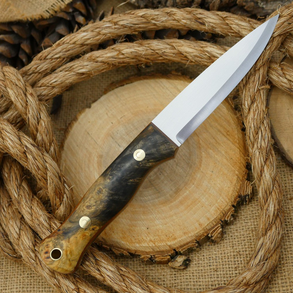 An Adventure Sworn Mountaineer bushcraft knife with Ohio buckeye burl handle scales and brown canvas liners.