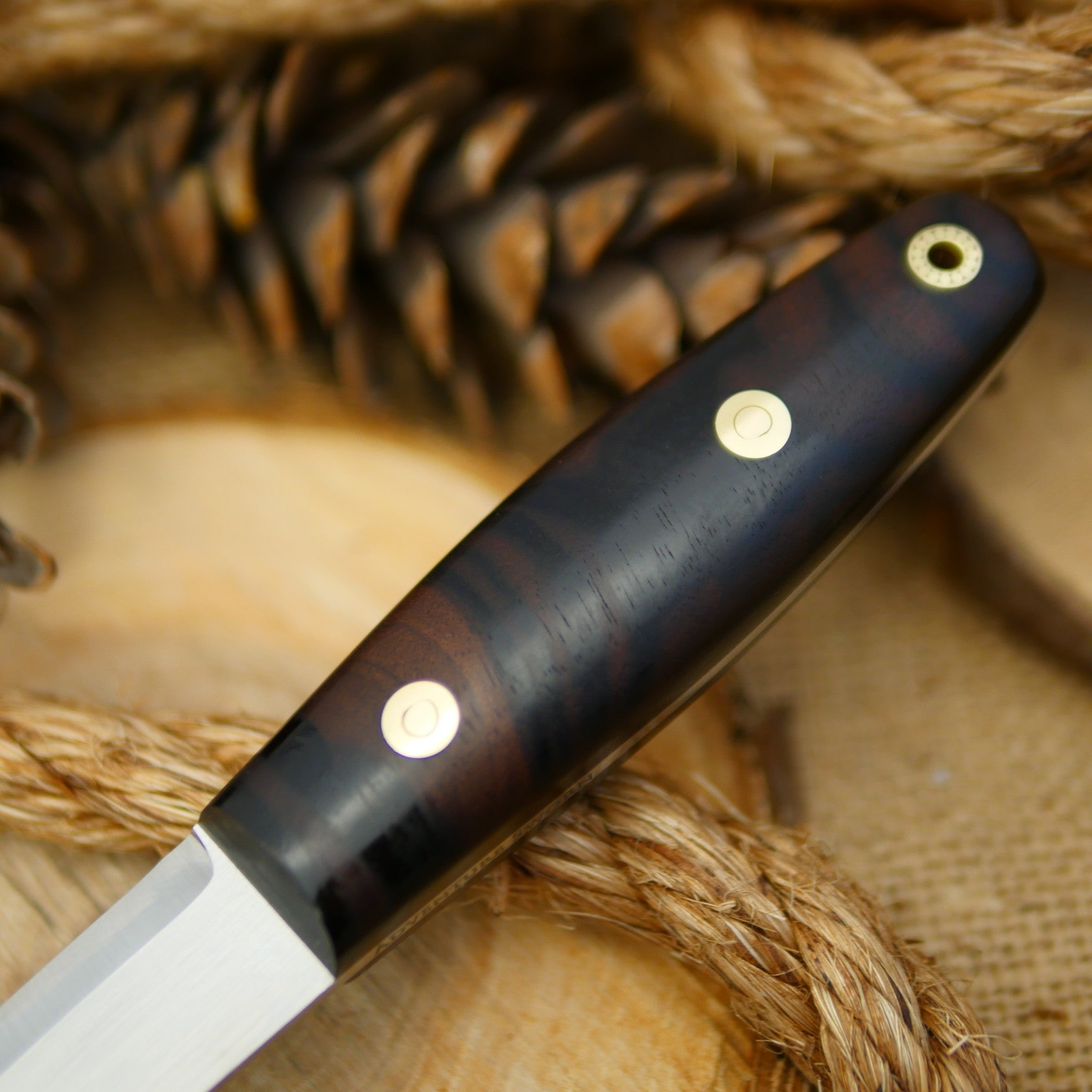 An Adventure Sworn Woodsman bushcraft knife with katalox handle scales.