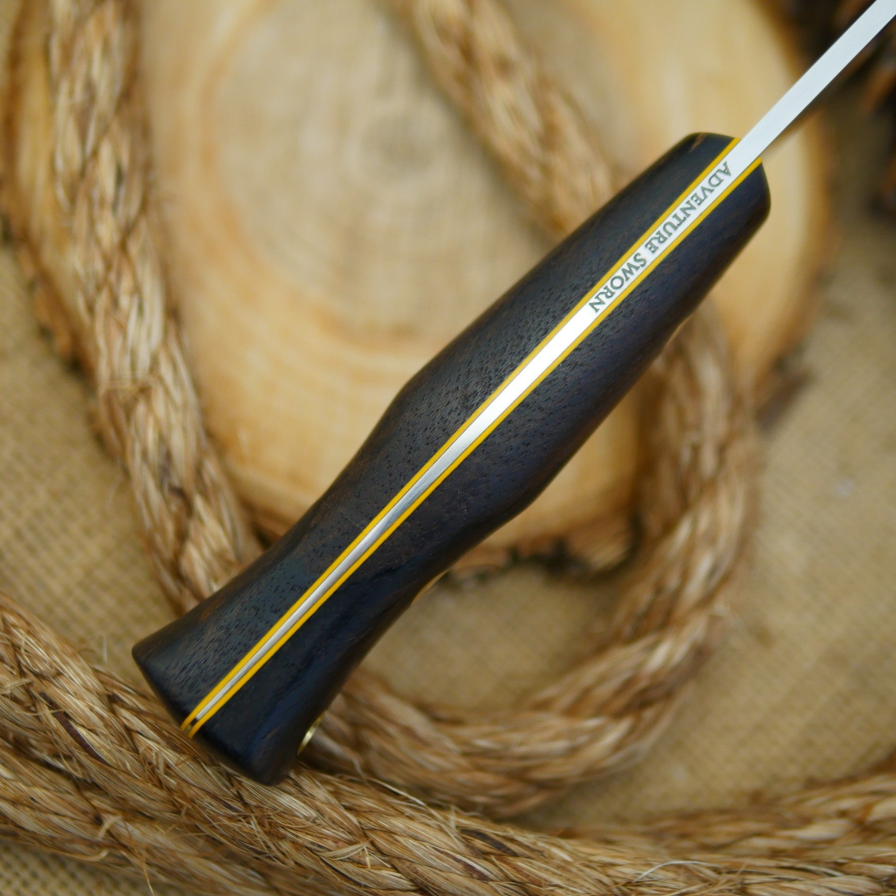 An Adventure Sworn Tradesman bushcraft knife with ziricote handle scales.