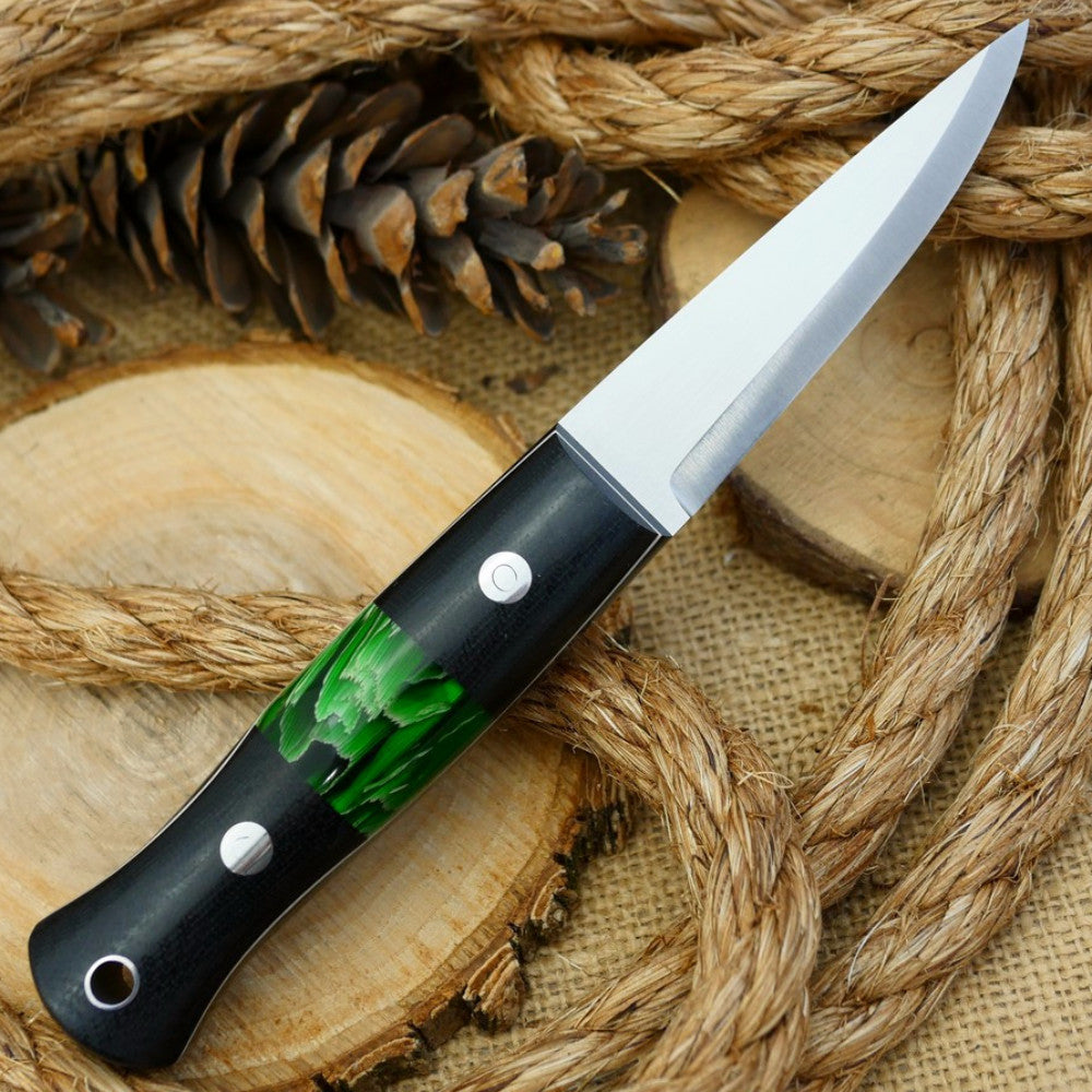 An Adventure Sworn bushcraft knife with black canvas micarta handle scales and green raffir stripes spacer.