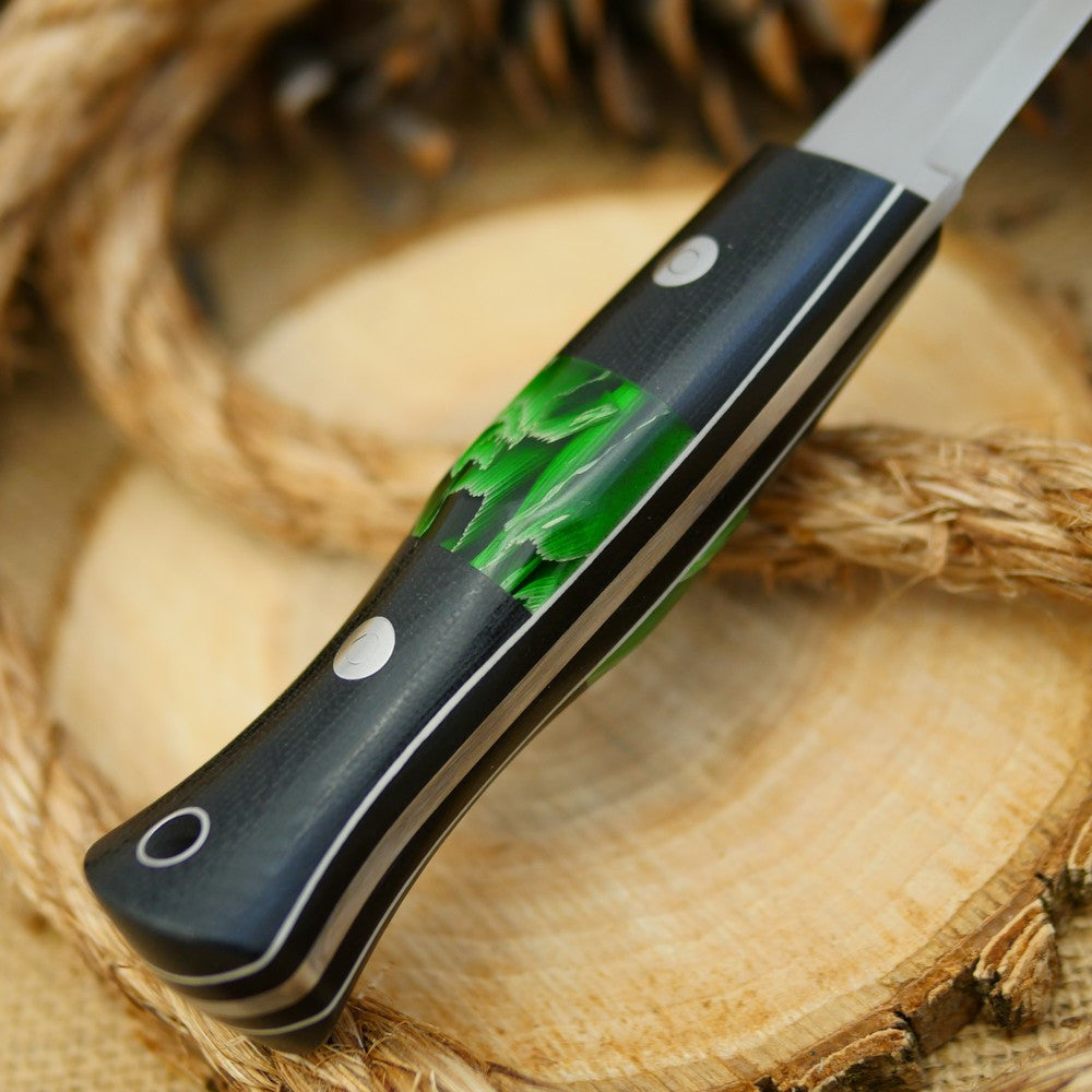An Adventure Sworn bushcraft knife with black canvas micarta handle scales and green raffir stripes spacer.