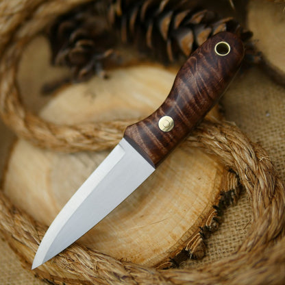 An Adventure Sworn Walker Bushcraft Knife with dark brown curly maple handle scales and thick maroon liners.