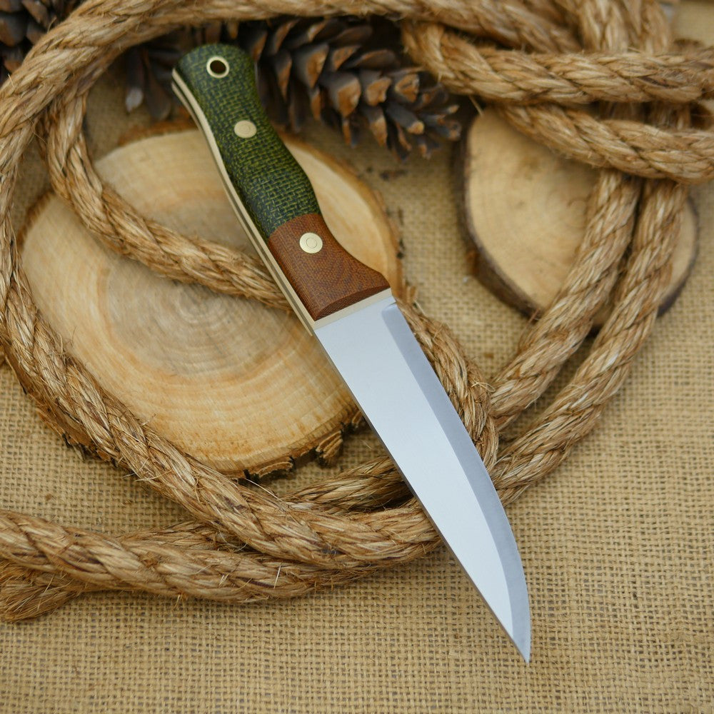 An Adventure Sworn bushcraft knife with evergreen burlap handle scales and natural brown canvas micarta bolster.
