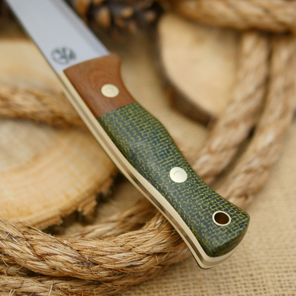 An Adventure Sworn bushcraft knife with evergreen burlap handle scales and natural brown canvas micarta bolster.