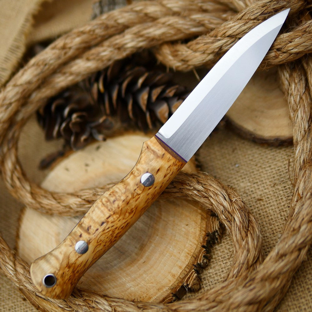 An Adventure Sworn Mountaineer bushcraft knife with karelian birch handle scales and thin blue and red liners.