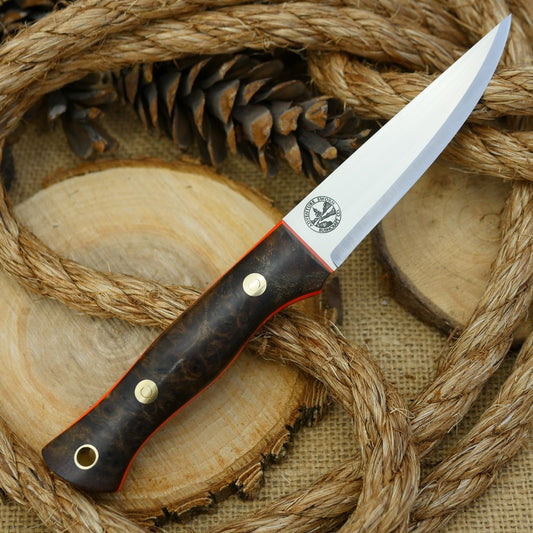 A Voyageur bushcraft knife with stabilized maple burl and hunter orange g10 liners.
