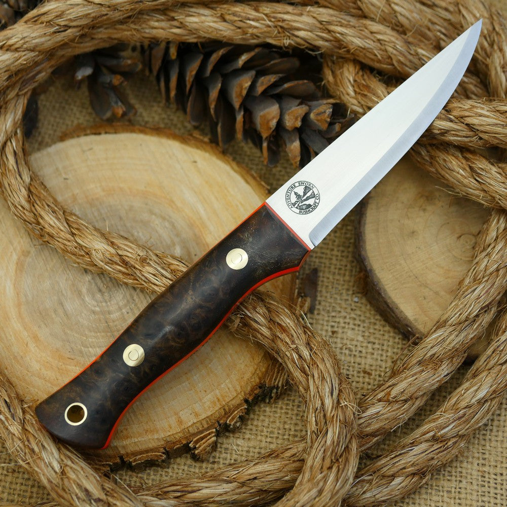 A Voyageur bushcraft knife with stabilized maple burl and hunter orange g10 liners.