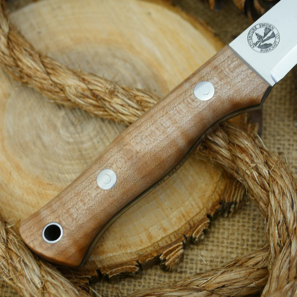 A Voyageur bushcraft knife with curly maple handle scales and double liners