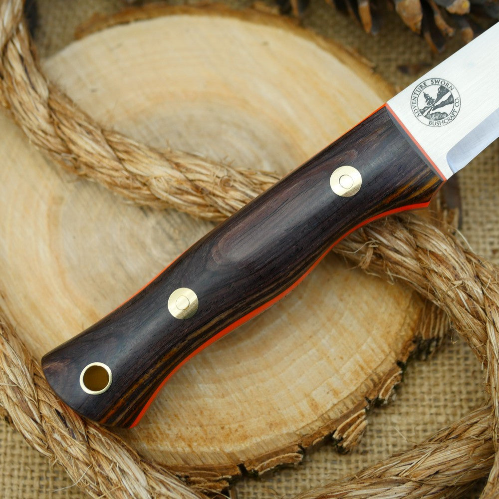 A Voyageur bushcraft knife with cocobolo handle scales and hunter orange g10 liners